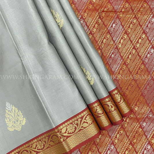 Grey saree with gold and red border featuring intricate patterns
